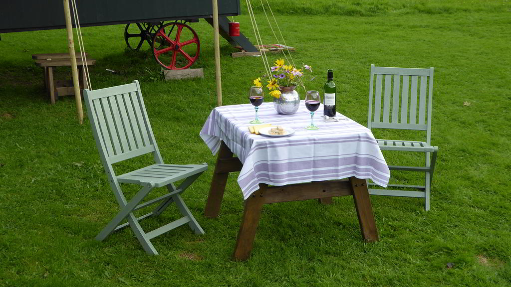 Table with wine set for dinner outside the Hygge Hut
